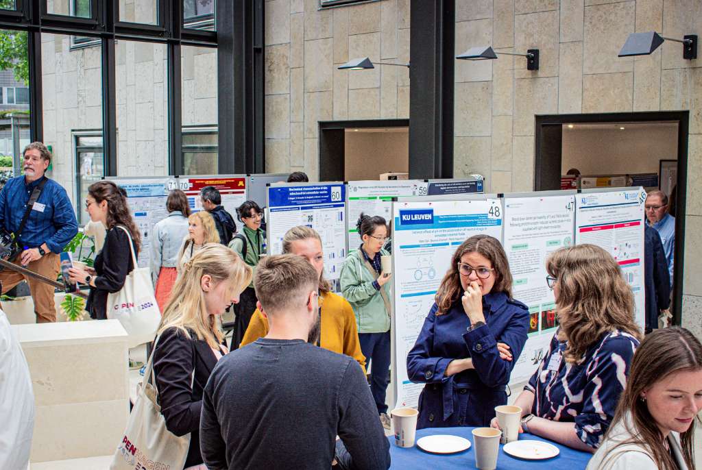 people talking in front of poster